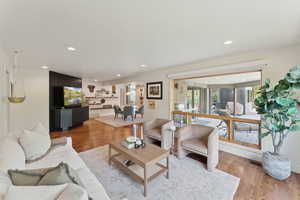 Living area featuring light wood finished floors and recessed lighting
