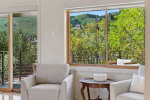 Living area featuring a view of trees