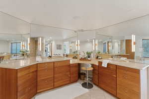 Bathroom with healthy amount of natural light, vanity, and recessed lighting