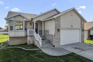 Ranch-style home with a front lawn and a garage