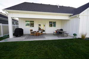 Rear view of property featuring a patio and a lawn