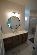 Bathroom featuring vanity, toilet, and a shower with shower door