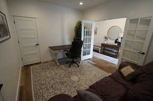 Office space with french doors and dark hardwood / wood-style flooring