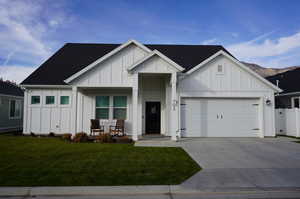 View of front of house with a front yard and a garage