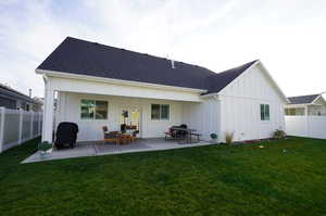 Back of house featuring a patio and a yard