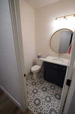 Bathroom featuring vanity, toilet, and tile patterned floors