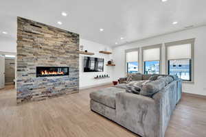 Living room featuring light hardwood / wood-style flooring and a fireplace