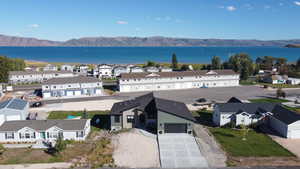 Birds eye view of property featuring a water and mountain view