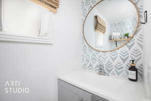 1/2 Bathroom with vanity and backsplash