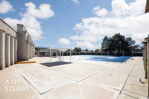 Community swimming pool with a patio