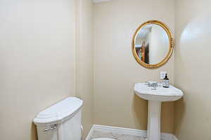 Bathroom with sink, toilet, and tile patterned flooring