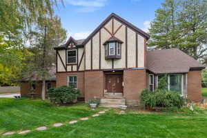 Tudor home with a front lawn