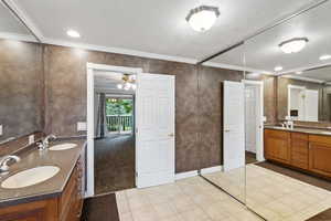 Bathroom with vanity, ceiling fan, and ornamental molding