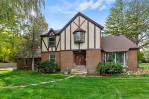 Tudor house featuring a front lawn