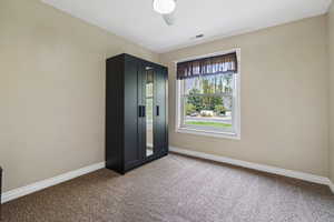 Unfurnished bedroom with carpet and ceiling fan