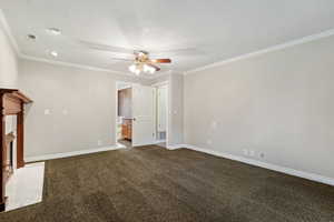 Unfurnished bedroom with ceiling fan, a textured ceiling, ornamental molding, ensuite bathroom, and dark colored carpet