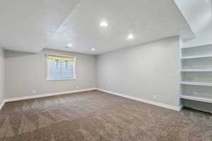 Interior space with carpet and a textured ceiling