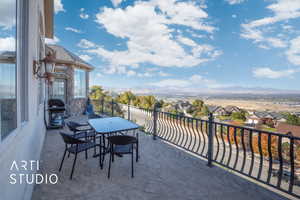 Balcony off of bedroom featuring valley and mountain views