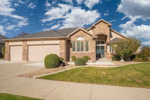 View of front of house with a front lawn and a garage