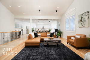 Interior space with hardwood / wood-style flooring and vaulted ceiling