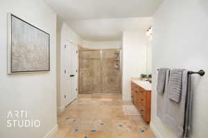 Bathroom featuring vanity and walk in shower.  Bathroom is attached to hallway and bedroom 5