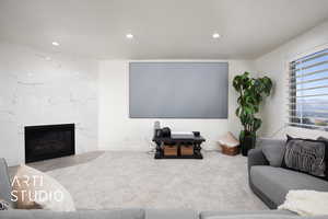 Recreation room with large screen for laser projector to watch movies or the big game. fireplace surrounded by marble.