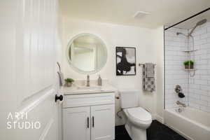 Full bathroom featuring vanity, toilet, tile patterned floors, and tiled shower / bath