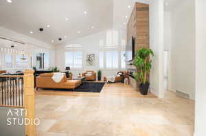 Living room featuring high vaulted ceiling and a wealth of natural light and views of Salt Lake Valley and Wasatch and  Oquirrh Mountains