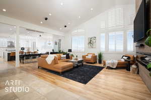 Living room featuring light hardwood / wood-style flooring and high vaulted ceiling