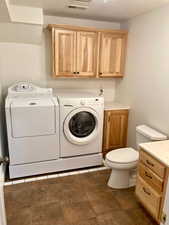 Laundry area with separate washer and dryer, Hickory Cabinets