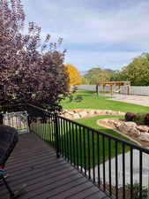 Wooden deck featuring a yard