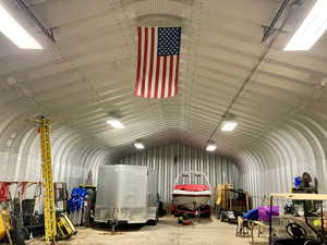 Misc room with lofted ceiling and concrete floors