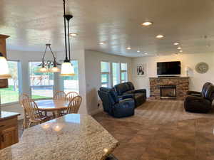 Living room with a textured ceiling and a fireplace