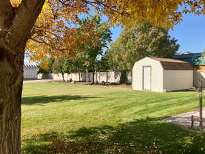 View of yard featuring a storage unit