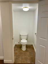 Bathroom featuring toilet and tile patterned flooring