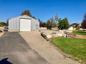 Exterior space featuring an outbuilding and a garage