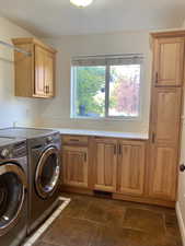 Laundry area featuring washer and dryer and Hickory cabinets