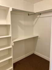 Walk in closet featuring carpet flooring his and hers