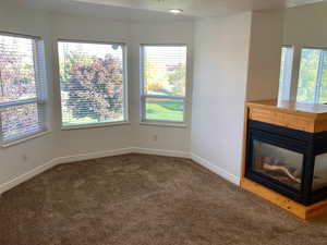 Interior space with a wealth of natural light and carpet floors