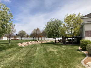 View of yard featuring fence and stairs, spring has begun