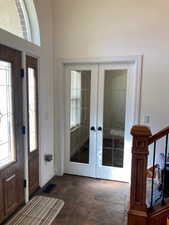 Foyer featuring french doors and a healthy amount of sunlight