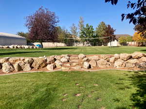 Surrounding community featuring a lawn and volleyball court