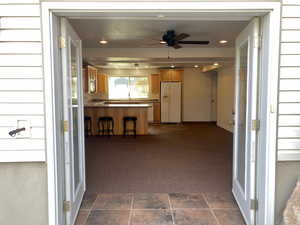 Interior space featuring ceiling fan, sink, and a patio area