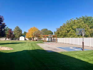 View of yard with a shed and basketball hoop