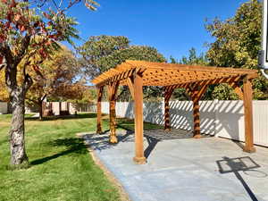 View of community featuring a patio, a lawn, and a pergola