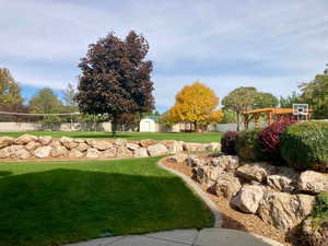 View of yard featuring a storage shed and volleyball court