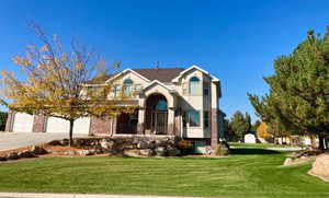 View of front of house featuring a garage and a front lawn