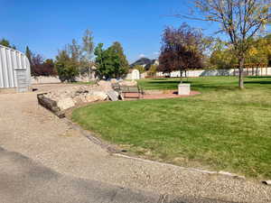 View of yard featuring a storage unit