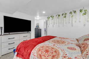 Bedroom with carpet floors and a textured ceiling