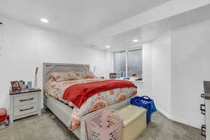 Bedroom with light colored carpet